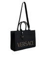 Sac fourre-tout à bandoulière en toile et cuir noir avec poignée supérieure et logo Versace